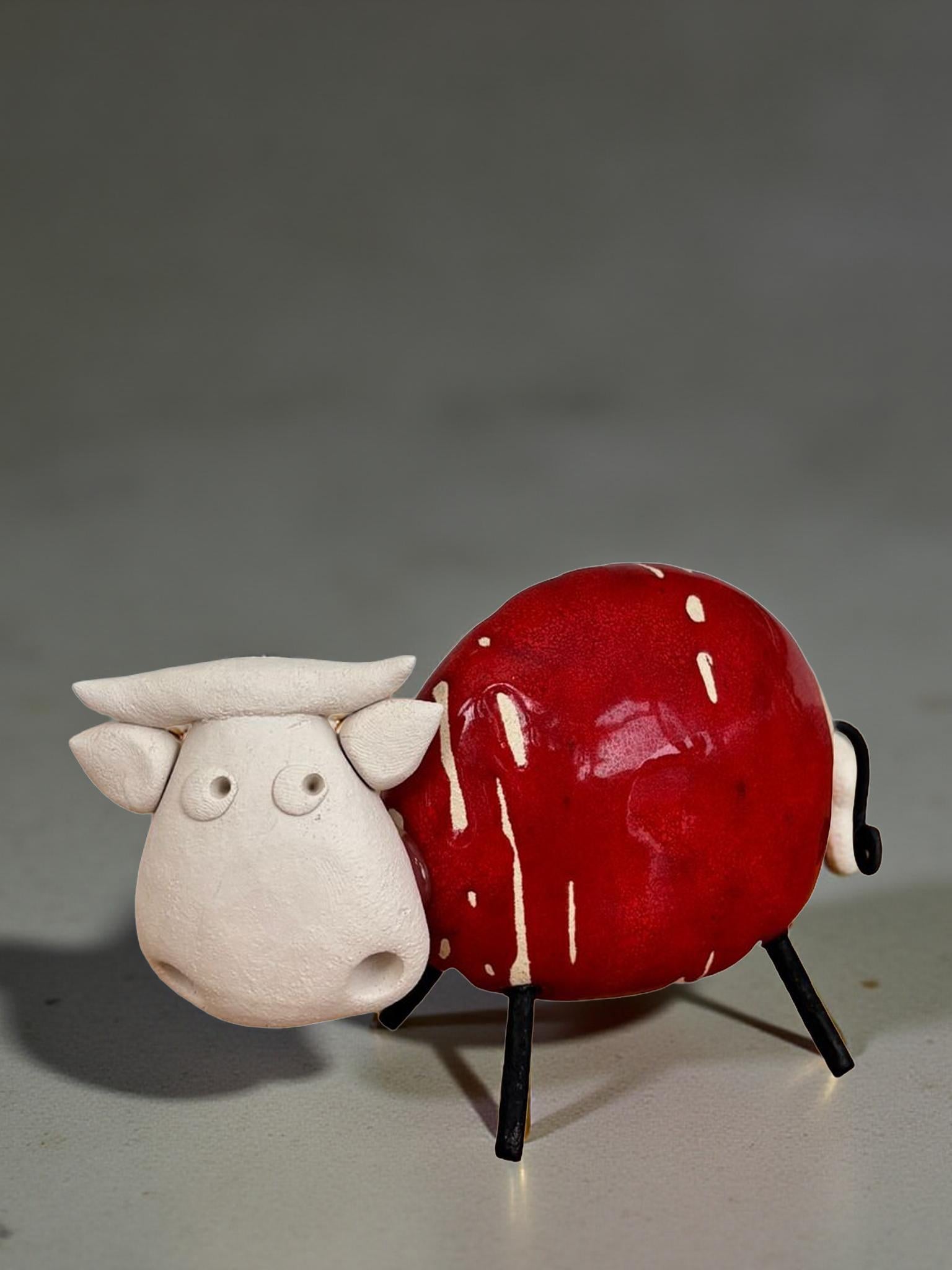 A red apple with white spots is depicted in the image, sitting on a gray surface.