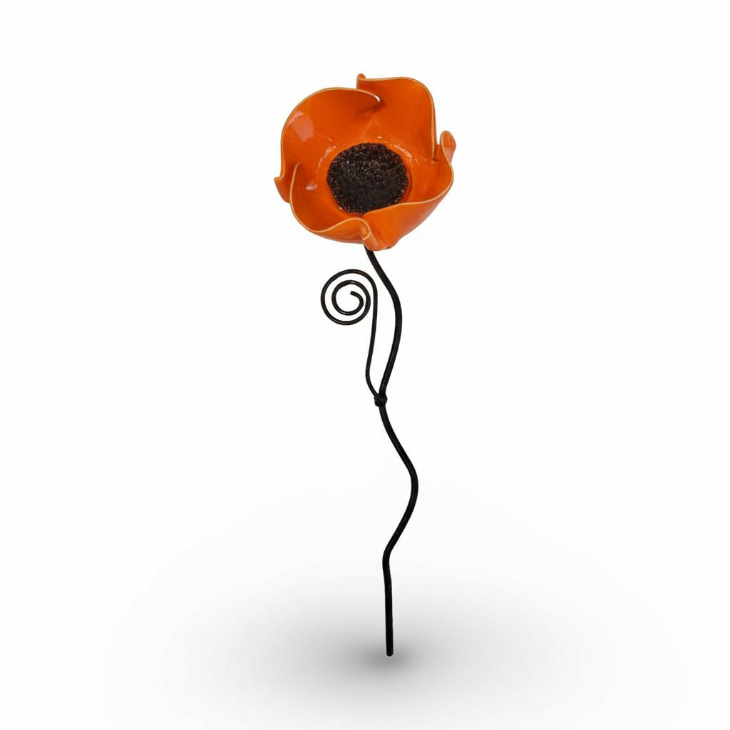 An orange glass flower with a black center is shown against a white background.