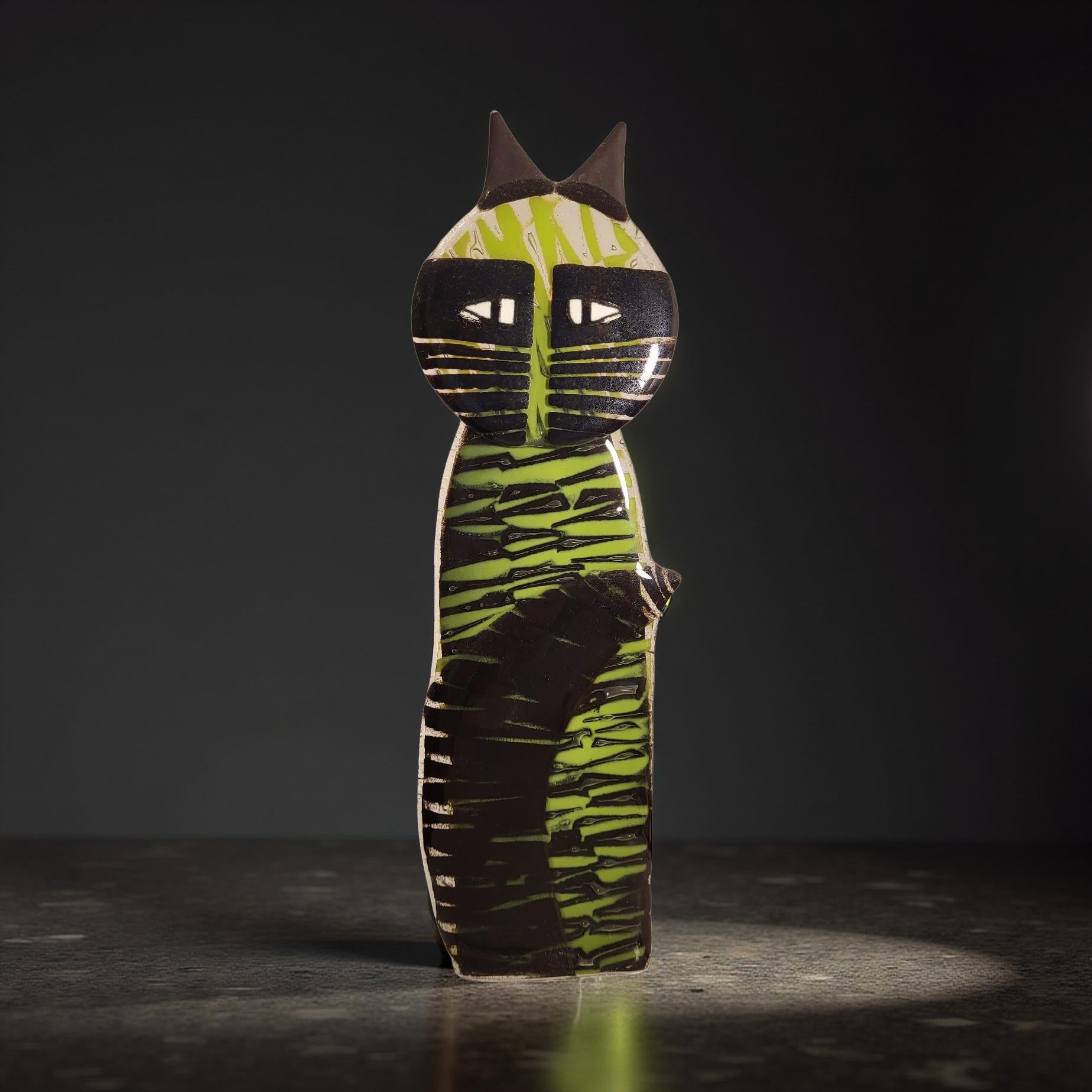A colorful, abstract cat-like figure made of various materials, including wood and fabric, stands on a dark surface against a dark background.